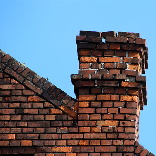 Brick house with damaged chimney masonry
