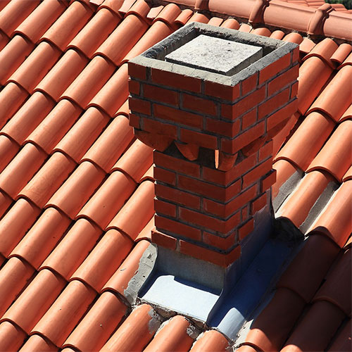 arial view of custom brick chimney with damaged masonry